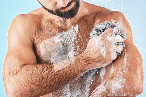 Image of Shower, soap and man washing body for hygiene, cleaning health and fresh morning on a blue studio background. Skincare, water and cosmetics model showering to clean skin for healthy lifestyle