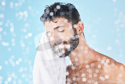 Image of Man, towel with cleaning face and beauty, bokeh overlay with hygiene and grooming against blue background. Skincare mockup with shower, clean cosmetic care and cotton fabric, facial and wellness