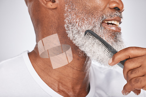 Image of Elderly, black man and comb for beard, beauty and grooming with hygiene and cleaning face zoom. Hair care, brush body hair and wellness with cosmetic care and natural against studio background