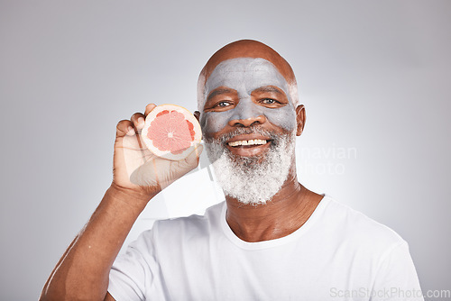 Image of Grapefruit, face mask and portrait of man, healthy skincare and beauty, wellness and makeup of anti aging, detox or natural facial cleaning. Happy face, studio male model and vitamin c fruits of glow