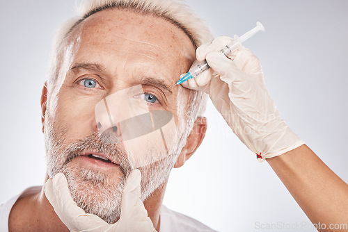 Image of Botox, face and portrait of a senior man doing a cosmetic anti aging treatment in the studio. Plastic cosmetology, filler and elderly guy with wrinkles getting a silicone injection by gray background