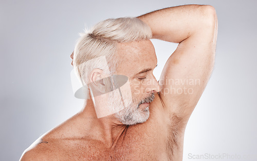 Image of Grooming, hygiene and man with fresh armpits, smelling clean and wellness after shower on a studio background. Healthcare, skincare and cosmetics senior model with underarm smell after cleaning body