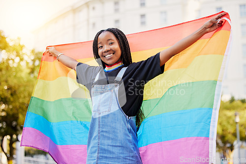 Image of Black gay woman, rainbow flag and lgbtq pride with a smile for sexuality freedom, non binary and gender neutral lifestyle. Portrait of young lesbian girl in city of France for equality and love