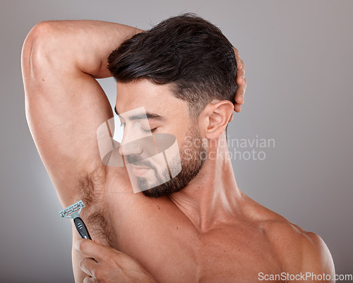 Image of Cosmetics, shaving armpit and man with skincare, hygiene and wellness on grey studio background. Male, guy and razor for hair removal, grooming and treatment for morning routine, fresh and beauty