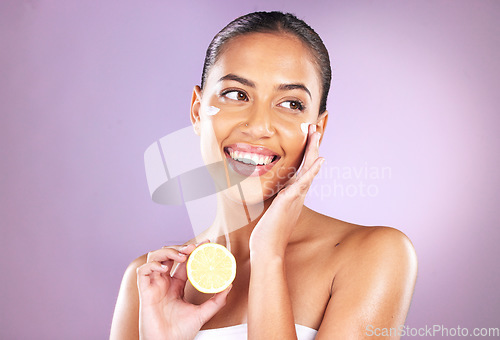 Image of Woman, face skincare or lemon cream on purple studio background for organic dermatology, healthcare wellness or self care grooming. Smile, happy or beauty model with fruit facial product or sunscreen