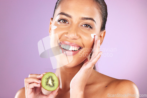 Image of Cream, kiwi and skincare woman in studio portrait for facial beauty, healthy glow or cosmetics advertising mockup. Self love model smile for vitamin c, nutrition or green fruit in dermatology product