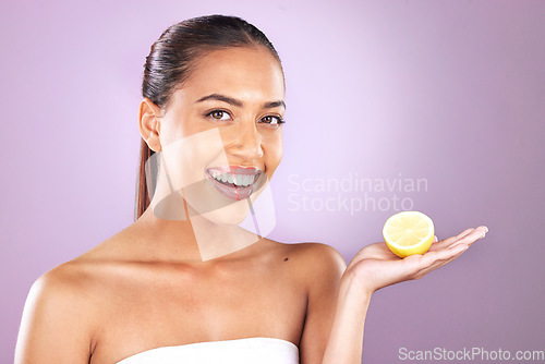 Image of Skincare, lemon and woman in studio mockup for beauty, cosmetics and wellness with vegan, health or vitamin c promotion on purple background. Skin care model and fruit for natural dermatology results