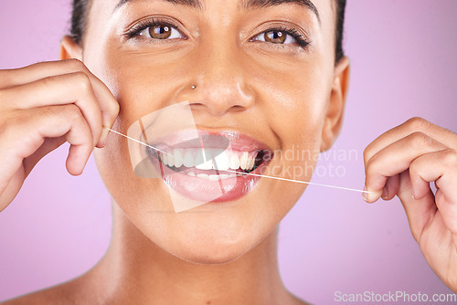 Image of Woman portrait, face or flossing teeth on studio background in hygiene mouth maintenance, self care grooming or healthcare wellness routine. Zoom, happy smile or beauty model in dental floss cleaning