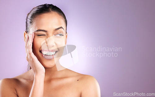 Image of Woman, smile and wink for skincare wellness or face dermatology beauty in purple studio background. Model, facial cosmetics care and natural glowing skin or comic happiness or headshot vision