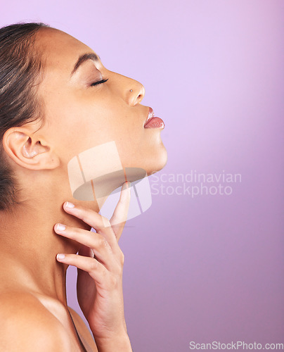 Image of Beauty, skincare and mockup with a model black woman touching her face in studio on a purple background. Wellness, luxury and cosmetics with an attractive young female posing to promote a product