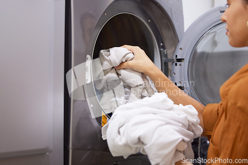 Image of Laundry, cleaning and woman with clothes in the washing machine for housekeeping, clean fabric and home spring cleaning. Service, clean and cleaner at a laundromat for morning housework routine