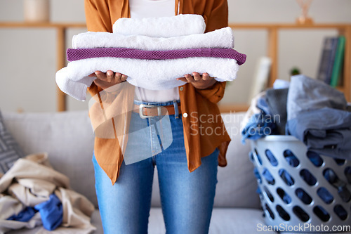 Image of Laundry, towel and texture with cleaning service and woman cleaner, hygiene and disinfection for housekeeping. Spring cleaning, clean fabric and housekeeper with fresh textile, washing and house work
