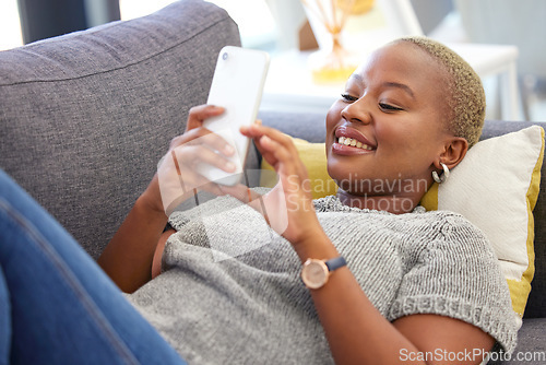 Image of Social media, relax and black woman with a phone for communication, mobile chat and app on the sofa. Connection, internet and calm African girl with a mobile for online conversation on the couch