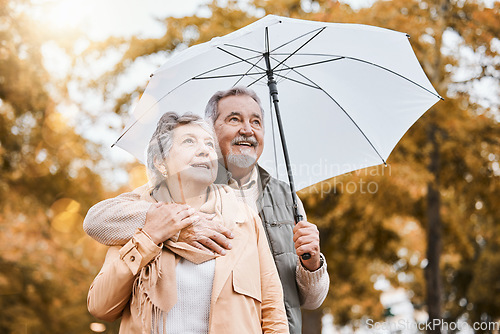 Image of Senior couple, umbrella and walking outdoor for relax freedom, calm quality time and relationship bonding in summer. Elderly man, woman and wellness walk in countryside park together for love or care