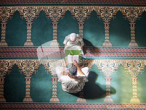 Image of Muslim pray, child or man in praying with Quran for peace, mindfulness or support from Allah in holy mosque. Top view, Islamic kid or person studying or praying to help worship God on Ramadan Kareem