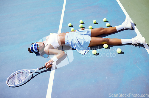Image of Tired, tennis and sad black woman on a court after a game, sports fitness and training fail in London. Depression, exercise and African tennis player on the floor after a loss in a professional match