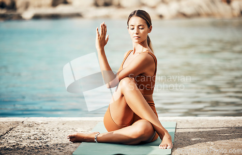 Image of Fitness, yoga and zen, woman at beach stretching for meditation and training in nature for healthy lifestyle. Health, wellness and workout for girl at ocean, pilates exercise for balance at sea water