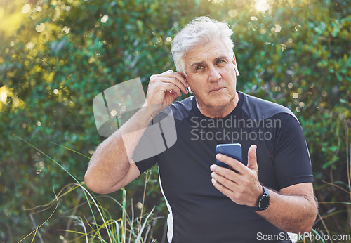 Image of Fitness, phone or old man listening to music, radio or motivational audio for running exercise or workout. Wellness, relaxing or senior person streaming a podcast or song in headphones in nature park