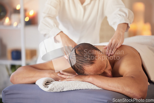 Image of Spa, man and massage for wellness, luxury and relax for health, peace or lying on table. Male person, rich and self care for healthy lifestyle, zen treatment or grooming for stress relief and healing