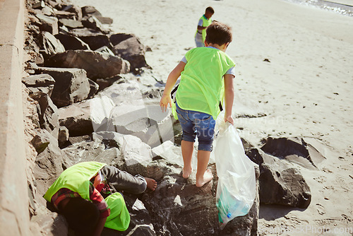 Image of Environment, cleaning and children with dirt on beach for clean up, pollution and eco friendly volunteer. Sustainability, recycle and kids reduce waste, pick up trash and plastic bag on beach sand