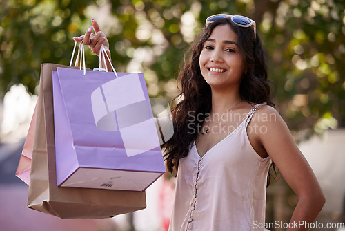 Image of Shopping bag, portrait and woman in park for fashion sale, promotion or discount deal in summer, spring holiday wealth, finance and commerce. Happy customer in city for fashion, sunglasses and retail