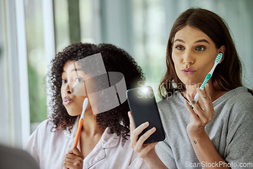 Image of Phone selfie, face and friends brushing teeth, goofy routine and morning social media update in a bathroom. Crazy, flash photo and women with toothbrush for dental care and mobile for picture