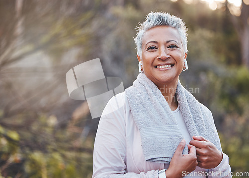 Image of Exercise, music and portrait of a senior woman outdoor with earphones and towel for fitness in nature. Elderly female in woods to run for healthy lifestyle, body and energy with cardio workout