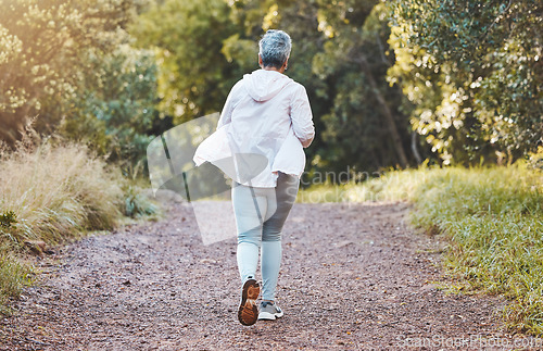 Image of Fitness, back and senior woman running in nature, park or outdoors alone. Sports, marathon and retired elderly female training, exercise jog or cardio workout for cardiovascular health and wellness.