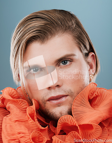 Image of Beauty, lgbtq and face of a man with fashion for self expression, non binary identity and creative style on blue background in studio. Retro, vintage and portrait of queer model in designer clothing