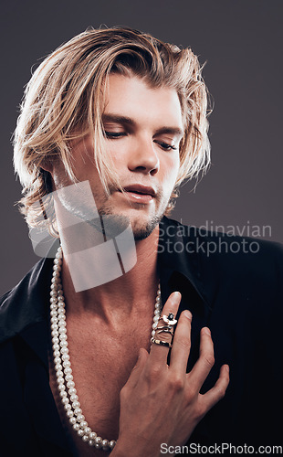 Image of Beauty, fashion and accessories with a man model in studio on a gray background for transsexual equality. Gender neutral, non binary and style with a handsome young male posing in designer clothes