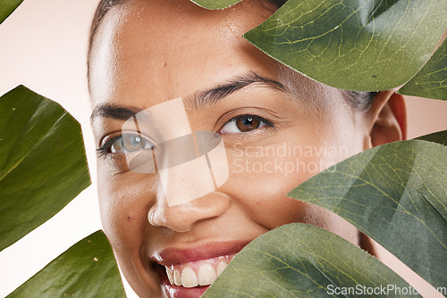 Image of Woman, closeup face and leaves in portrait for beauty, cosmetic wellness and smile, face glow and makeup. Model, skin health and facial cosmetics, self care and aesthetic with monstera by backdrop