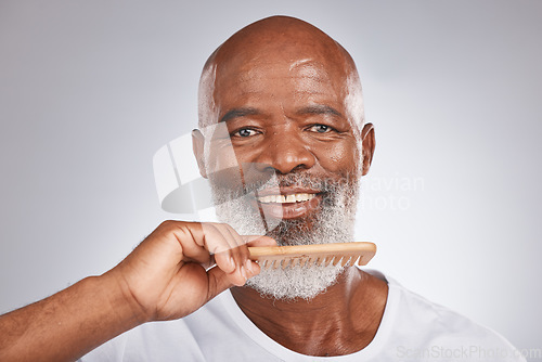 Image of Elderly, black man with comb for beard, beauty and grooming with hygiene and cosmetic care against studio background. Hair care mockup, brush body hair and face portrait with treatment and cosmetics