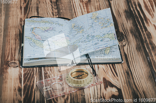 Image of Transparent plastic compass on wooden background