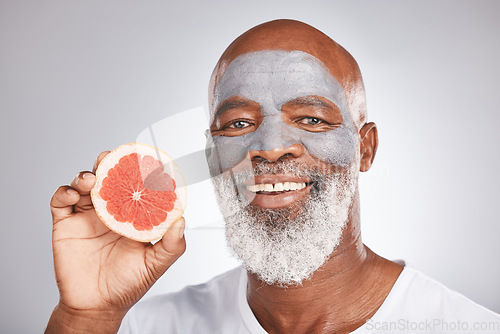 Image of Beauty, grapefruit or happy old man with face mask marketing or advertising skincare or healthy diet. Studio background, fruit or senior black man with a happy smile grooming with natural cosmetics