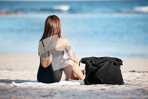 Image of Young woman sitting on beach, peace by the ocean horizon on summer holiday and Mauritius vacation. Female tourist relaxing at sea, freedom of travelling alone and peaceful content in outdoors