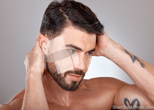 Image of Face, beauty and a man with clean, glow and healthy skin on a grey studio background for skincare, dermatology and hygiene. Headshot of a male with a barber haircut and cosmetics for self care