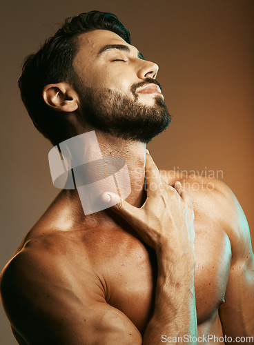 Image of Man, body or hand touching muscles on studio background for training, exercise goals or workout aesthetic in physical wellness. Bodybuilder skin, fitness model or athlete person and self love goals