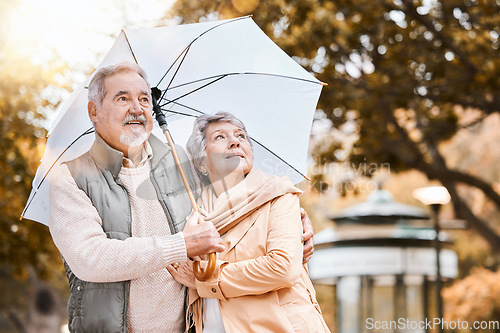 Image of Senior couple, umbrella and walking outdoor for relax freedom, calm quality time and relationship bonding in summer. Elderly man, woman and wellness walk in countryside park together for love or care