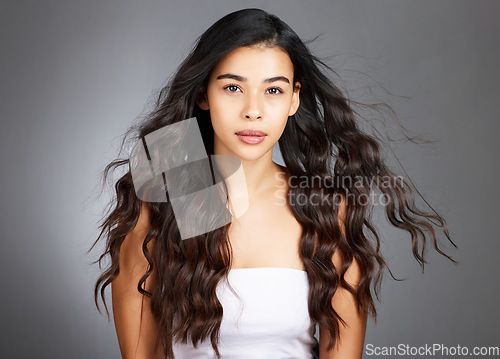 Image of Hair, hair care and woman, face and beauty, glow and shine with keratin treatment. Cosmetic mockup, waves and texture with hair style with studio background. Wellness, self care portrait and growth.