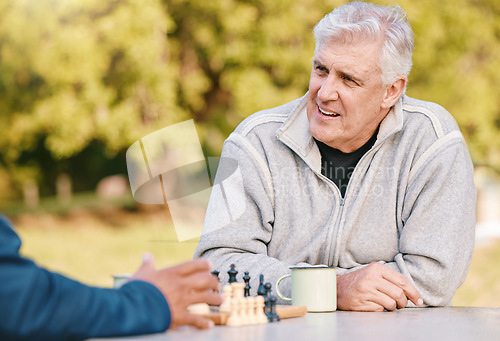 Image of Chess, nature and retirement with senior friends playing a boardgame while bonding outdoor during summer. Park, strategy and game with a mature man and friend thinking about the mental challenge