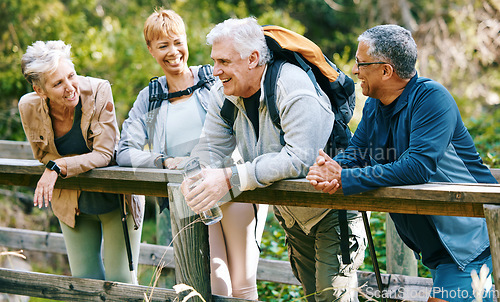 Image of Elderly, people hiking and happy in park with fitness outdoor, relax on bridge while trekking in nature together. Health, wellness and hiker group, sport and active lifestyle motivation with cardio.