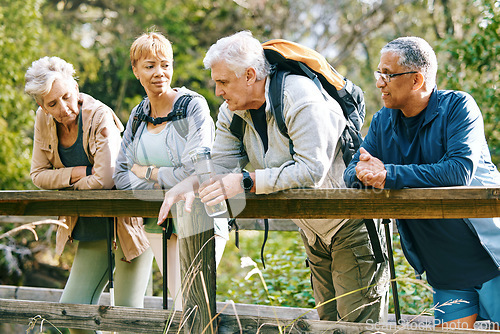 Image of Elderly, people hiking and happy in park with fitness outdoor, relax on bridge while trekking in nature together. Health, wellness and hiker group, sport and active lifestyle motivation with cardio.