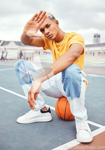 Image of Basketball, fashion and portrait of black man on basketball court with hand frame for beauty, style and outfit. Sports, leisure and and male model with hand frame and edgy clothes in urban park
