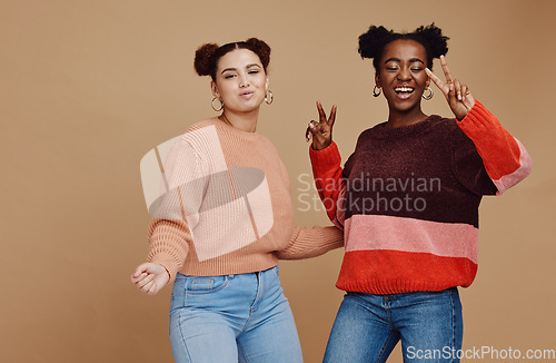 Image of Peace sign, fashion and women friends in studio with hand gesture, smile and happiness on brown background. Love, friendship and black woman with happy girl for relaxing, cosmetics and emoji together