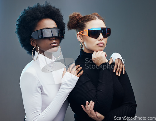 Image of Fashion, futuristic and cyberpunk with women in sunglasses, young and trendy designer brand with gen z youth. Marketing, diversity and future style with vision and edgy against studio background