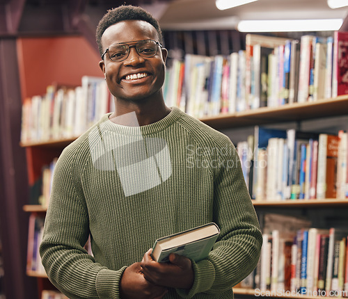 Image of Black man, student and portrait in library for book, research and education at college with smile. African gen z learner, books and shelf at university for goals, learning and motivation for future