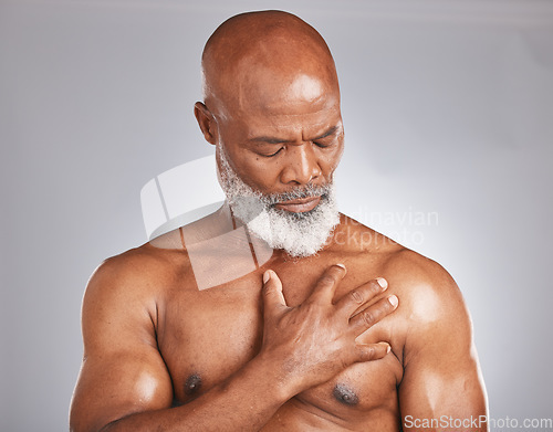 Image of Senior black man, hand holding chest pain on gray background and medical emergency in retirement age. Heart problem, effects of stress on old body or elderly african person with muscle injury