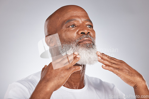 Image of Black man, face and senior self care for beard and facial. hair while grooming or shaving for clean skin. Headshot of African male on grey studio background for beauty, skincare and dermatology