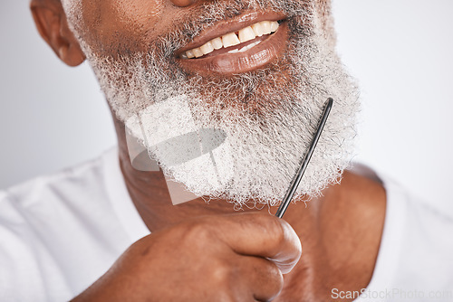 Image of Elderly, black man with comb for beard, beauty and grooming zoom with face hygiene and cosmetic care. Facial hair closeup, brush body hair and treatment with cosmetics against studio background