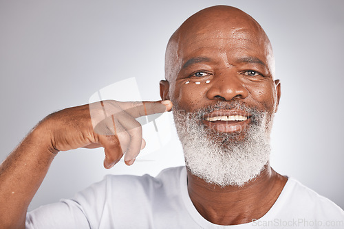 Image of Beauty, face cream and skincare of black man in studio for self care with skincare, dermatology and cosmetics. Portrait of happy senior male with lotion on skin for glow, health and wellness on grey